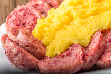 pork sausage (cotechino) with polenta on the wood table