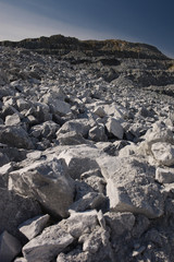 Destroyed rocks after the explosion inside a large quarry. Mining industry.