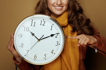 Woman pointing at clock remind about autumn time change