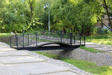 small form-bridge over the canal in the Park