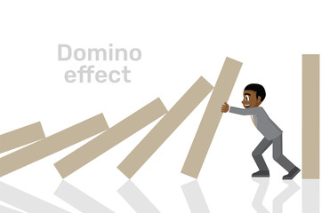 African businessman trying to stop domino effect.