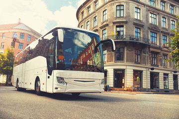 tourist bus carries tourists by city - obrazy, fototapety, plakaty