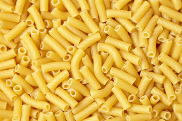 Tortiglioni italian pasta texture background, top view