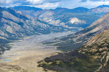 The Kaskawulsh river flows below mountains in Kluane National Park, Yukon, Canada