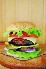 Juicy burger on a wooden background