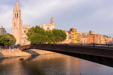 Colorful yellow and orange houses reflected in water river Onyar, in Girona, Catalonia, Spain.