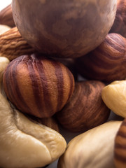 Blend of fresh healthy tasty nuts on white background