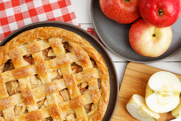 Homemade apple pie with lattice on white wooden table. Top view.