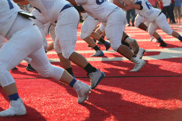 High school football players practice prior to the start of a game.
