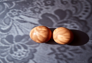2 brown chicken eggs on a metal surface