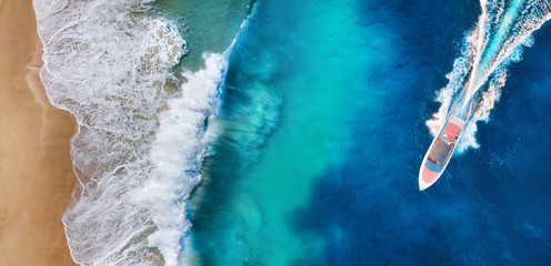 Aerial view of luxury floating boat. Panorama of a coast and fast boat as a background from top...