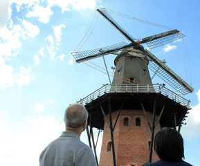 couple observing an old windmill