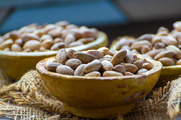 Clay bowls with dried pistachio nuts close up