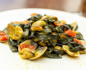 Seafood pasta dish, Italian black fettuccini with vongole clams and mussels