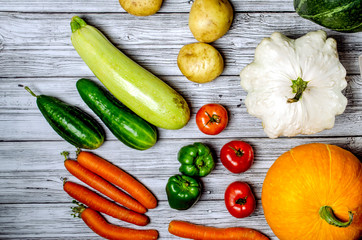 Fresh colorful organic vegetables shot from above top view, flat lay . Worktop wooden table as a background.Pumpkin
