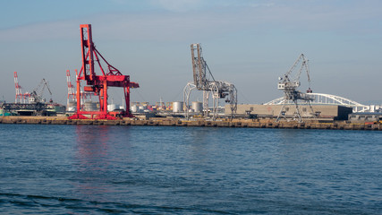 Fototapeta na wymiar Crane in port of Osaka in Japan. View to the cranes in port