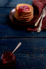 Tasty breakfast. Pancakes with strawberry confiture and butter.