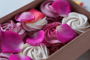 white and pink marshmallows, marshmallows in a gift box. sweet gift. garnished with rose petals. 