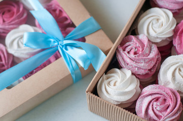 white and pink marshmallows, marshmallows in a gift box. sweet gift. garnished with rose petals. 