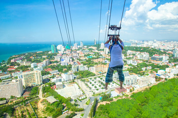 Thailand. Pattaya. Descent on a cable from a skyscraper in Pattaya. Extreme entertainment....