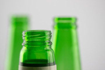Colorful empty beer bottles, lots of empty beer bottles. Closeup, daylight. Beer's over, party's over.