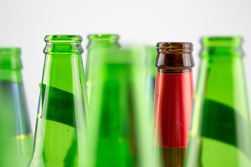 Colorful empty beer bottles, lots of empty beer bottles. Closeup, daylight. Beer's over, party's over.