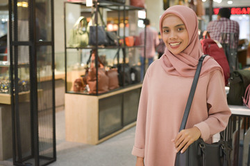 Portrait of young asian muslim women shopping in mall.