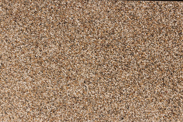 Fragment of a wall covered with fine stone. Modern building mate