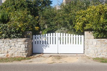 Gate of a property in white plastic