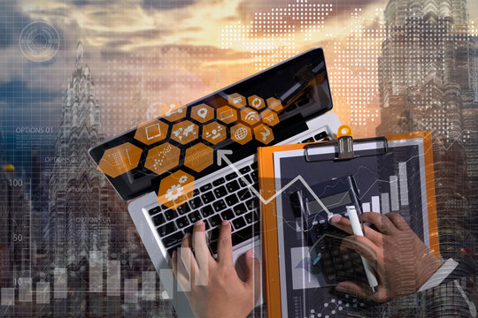 Double exposure of businessman using the tablet with cityscape and financial graph on blurred building background,