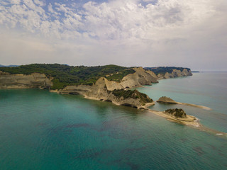 Aerial photo of iconic white rock steep cliff volcanic bay of Cape Drastis and Peroulades area with tropical deep turquoise clear sea. Photo from drone. Corfu island, Ionian, Greece