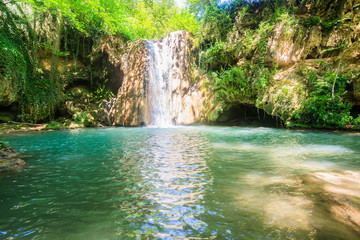 Scenic View Of Waterfall In Forest On Summer Day