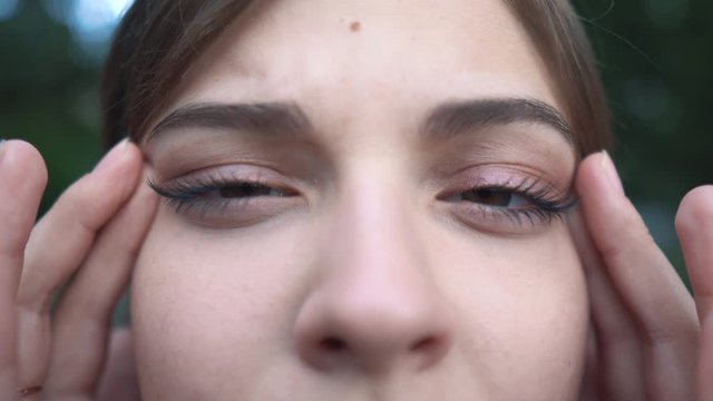 Girl with poor eyesight. Helps fingers squint eyes. astigmatism, hyperopia, myopia. Close-up