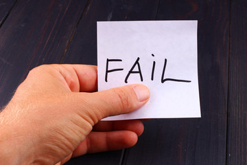 Fail Word on paper in hand