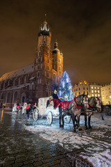 Naklejka na ściany i meble St. Mary's Basilica, horse-drawn carriages. Christmas tree. Krakow . Main Market square