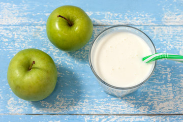 Ayran, homemade yogurt drink kefir, lassi with cucumbers - healthy summer refreshing cold drink on blue. Top view.