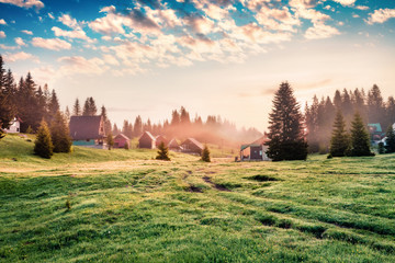 Amazing summer sunrise in Durmitor Nacionalni Park. Picturesque foggy view of Kovachka Dolina village, Montenegro, Europe. Beautiful world of Mediterranean countries. Traveling concept background. © Andrew Mayovskyy