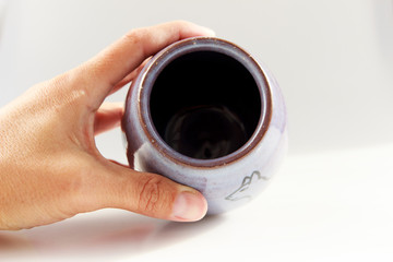 small vase with an Egyptian cat made of red clay covered with transparent glaze. Ancient Egyptian hieroglyph. the glaze turned violet due to excess firing temperature.