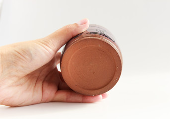 small vase with an Egyptian cat made of red clay covered with transparent glaze. Ancient Egyptian hieroglyph. the glaze turned violet due to excess firing temperature. bottom