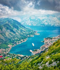 Fototapeta na wymiar Fantastic summer cityscape of Kotor port. Aerial morning view of Kotor bay and limestone cliffs of Mt. Lovcen. Sunny Adriatic seascape. Beautiful world of Mediterranean countries. 