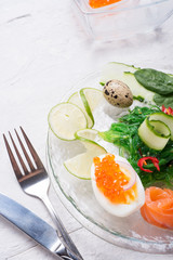 fresh  gourmet salad with  salmon, caviar, eggs and vegetables. served on white table.   Protein luxury delicacy  healthy food. beautifull served.  close up