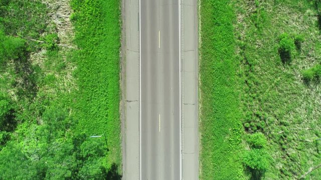 Drone Aerial Overhead Of Rural Highway With Cars Driving On Road. Themes Of Freedom, Exploring, Transportation, Infrastructure, Adventure, Open Road. Prores File, Shot In 4K.