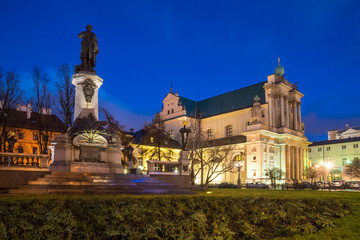 Fototapeta na wymiar Mickiewicz Monument and Church of the Assumption of the Virgin Mary and of St. Joseph known as the Carmelite Church at night.