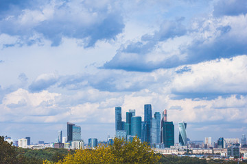 Panoramic view of the city of Moscow from the Sparrow Hills, Russia. Mirror skyscrapers of the Moscow City business center against a blue sky