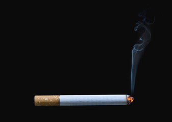 Cigarette burning isolated on black background