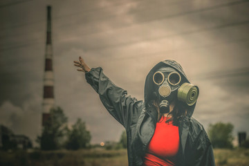 Woman in gas mask showing on a smoking chimney.