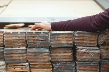 Buyer is byiung a wooden plank timber in a store.