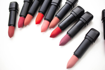 lipstick in different natural colors on a white background. Top view