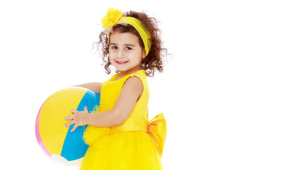 Little girl is playing with a ball.The concept of children's spo