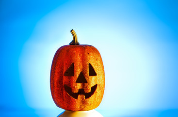Pumpkin halloween smiling face on a blue gradient background